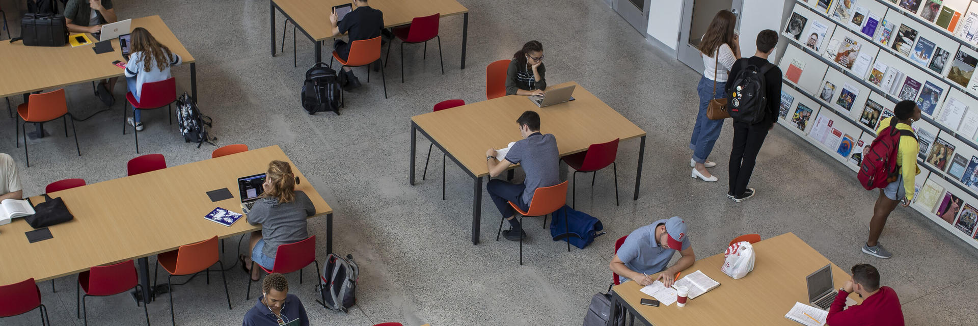 Students working at tables in the Charles Library.